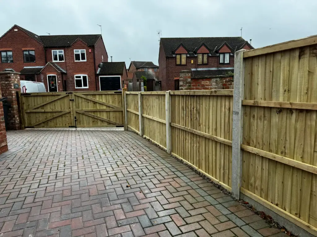 Block paving driveway running the full width between fenced boundaries