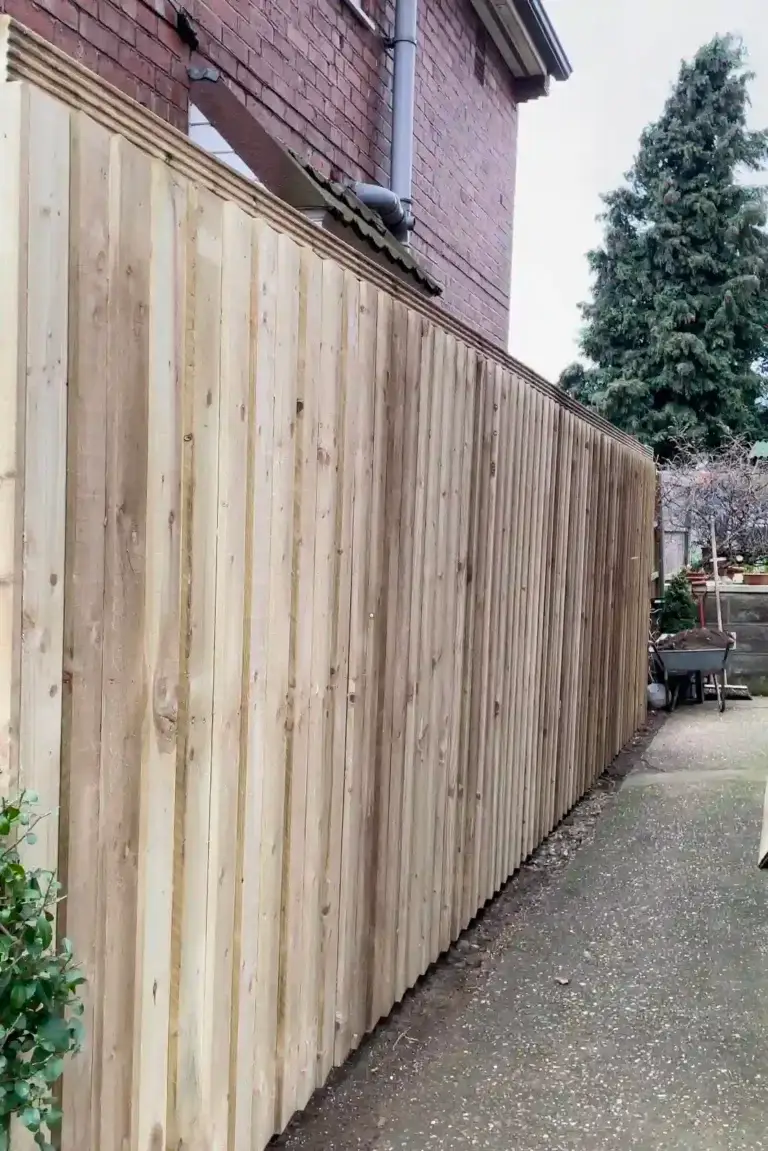 Closeboard wooden fence installation beside a red brick home in Gainsborough, Lincolnshire, pressure-treated timber panels fitted by landscapers