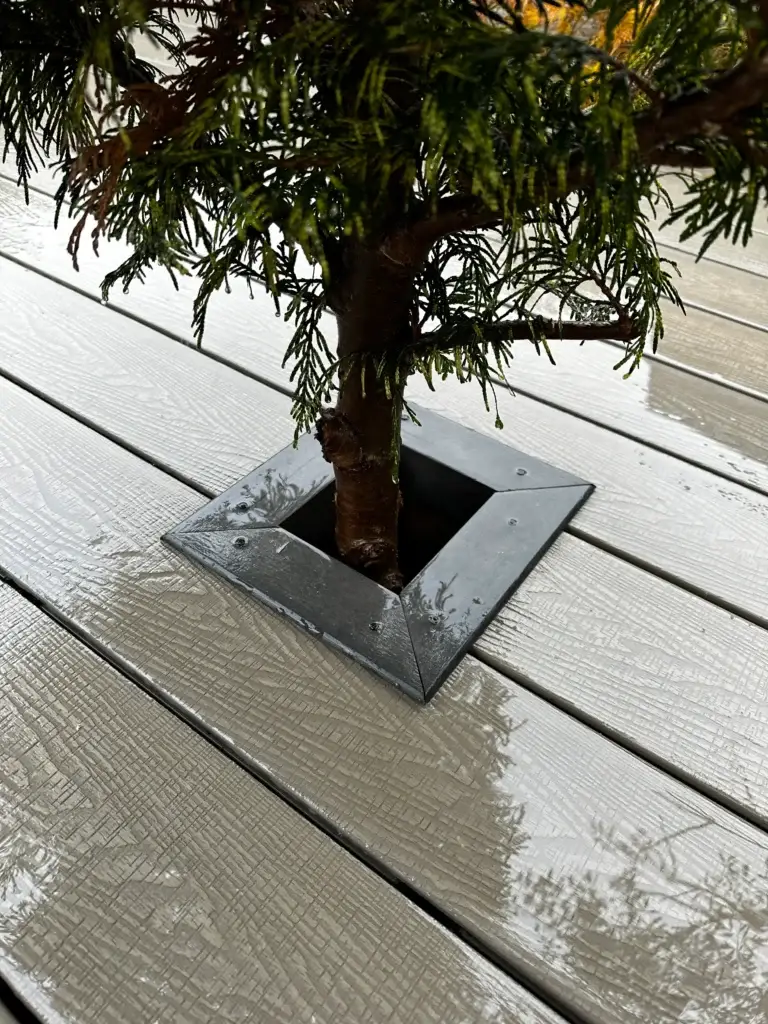 Composite decking detail with integrated tree surround installed by garden landscapers in Gainsborough, featuring modern grey decking boards