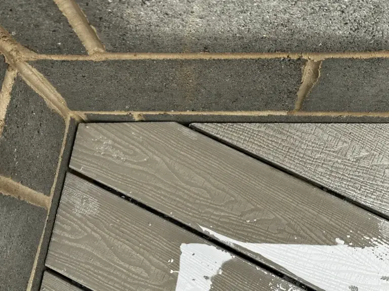 Light grey composite decking corner detail installed by garden landscapers in Lincoln, featuring precision mitred edges and hidden fixings