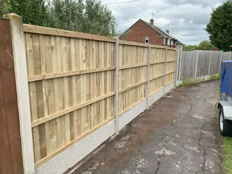 Timber fence panels with concrete posts and gravel boards installed along a residential driveway in Gainsborough, Lincolnshire, professional garden fencing installation by landscapers in Gainsborough