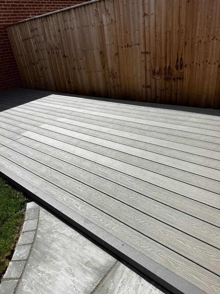 Light grey composite decking installation in Gainsborough by garden landscapers in Gainsborough, featuring flush edging and anti-slip woodgrain finish