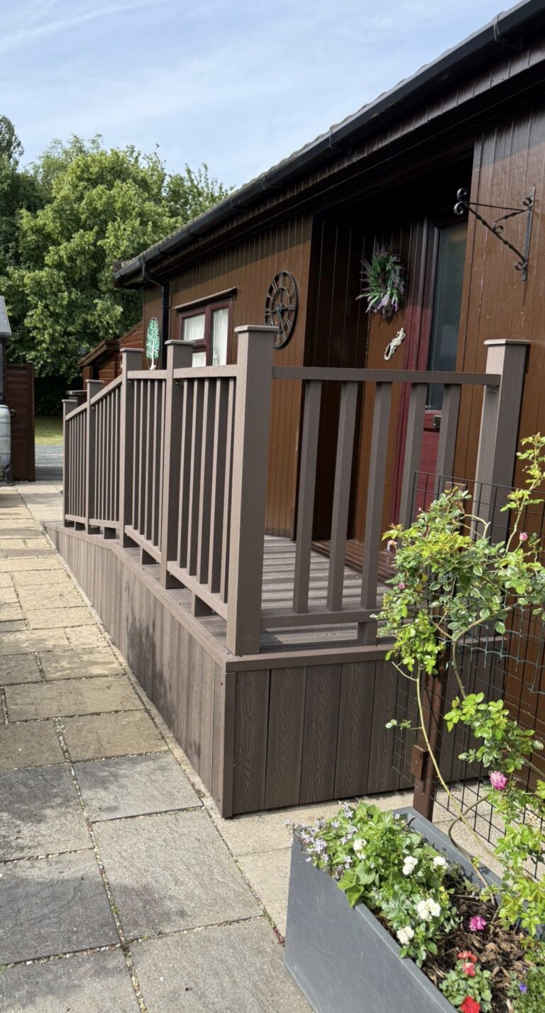 Premium composite decking with matching balustrade installed alongside lodge for safe and low-maintenance access