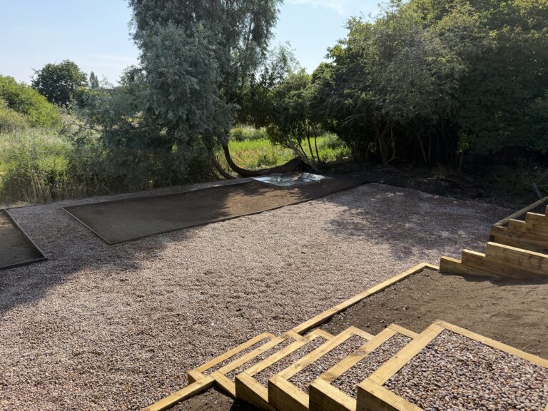 Complete garden makeover in Lincoln featuring decorative gravel, timber sleeper retaining walls, new patio areas and lawn preparation completed by Reshape Landscaping
