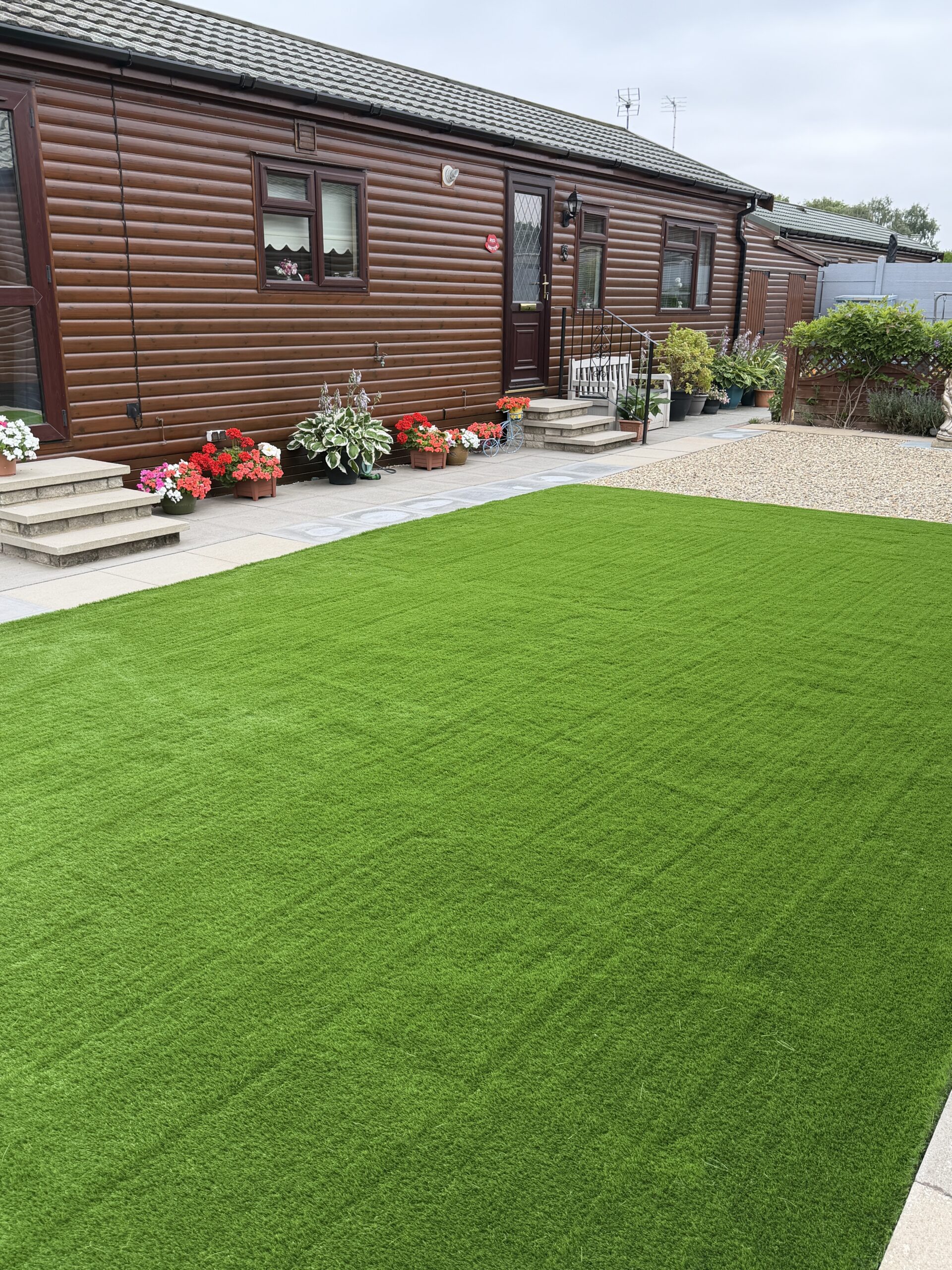 Lawn running up to a patio in a low maintenance garden near Lincoln