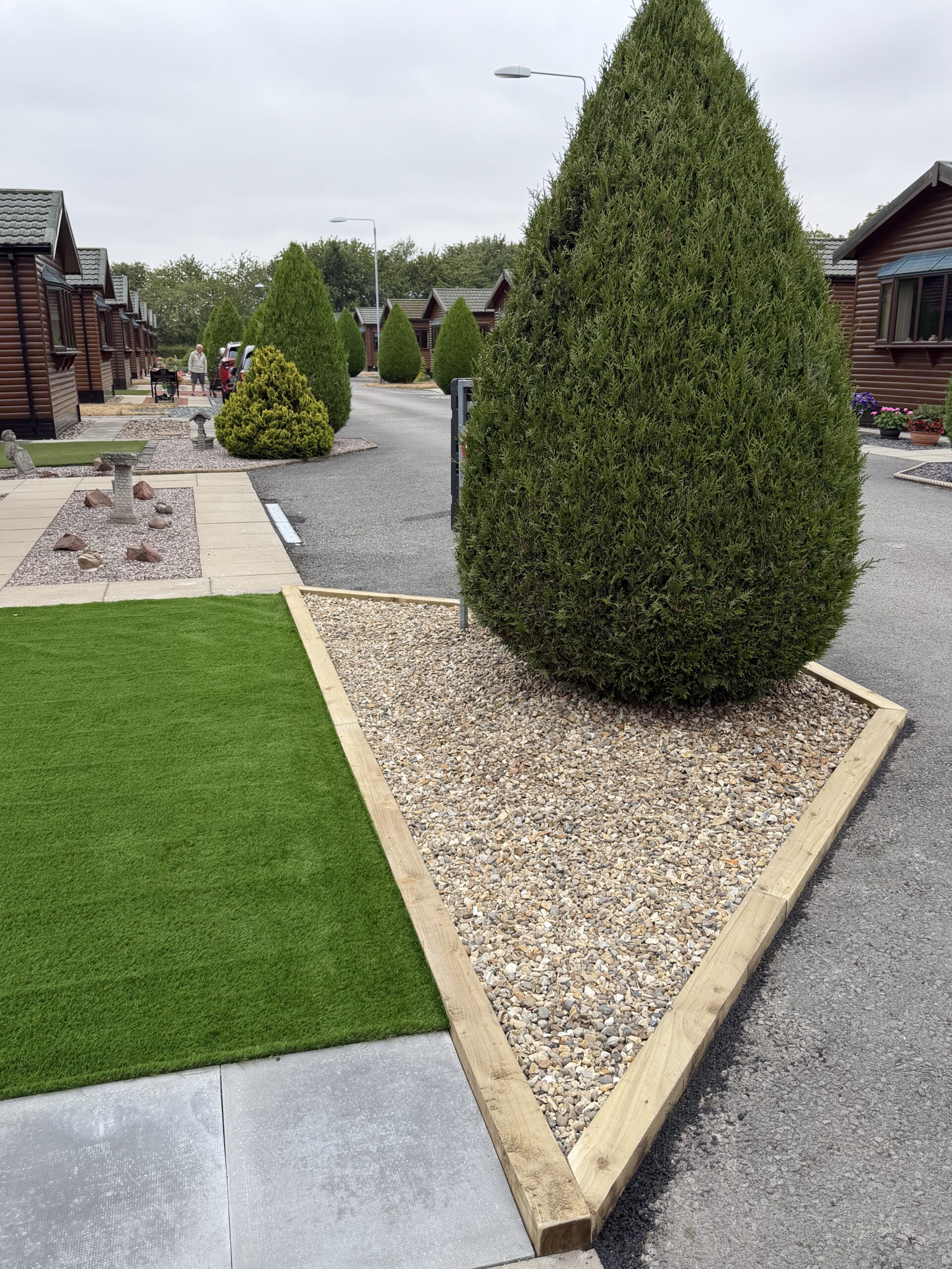 Garden lawn beside a gravel border and clipped topiary near Lincoln