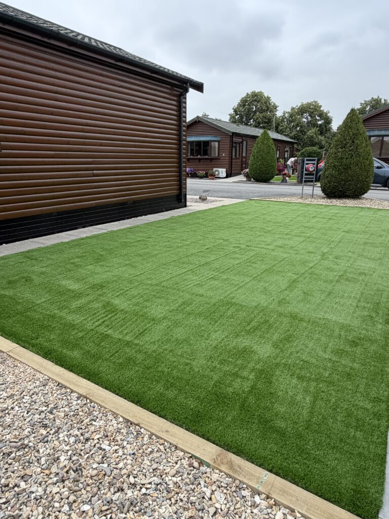 Low maintenance garden with artificial grass and decorative gravel borders, landscaped in Lincolnshire