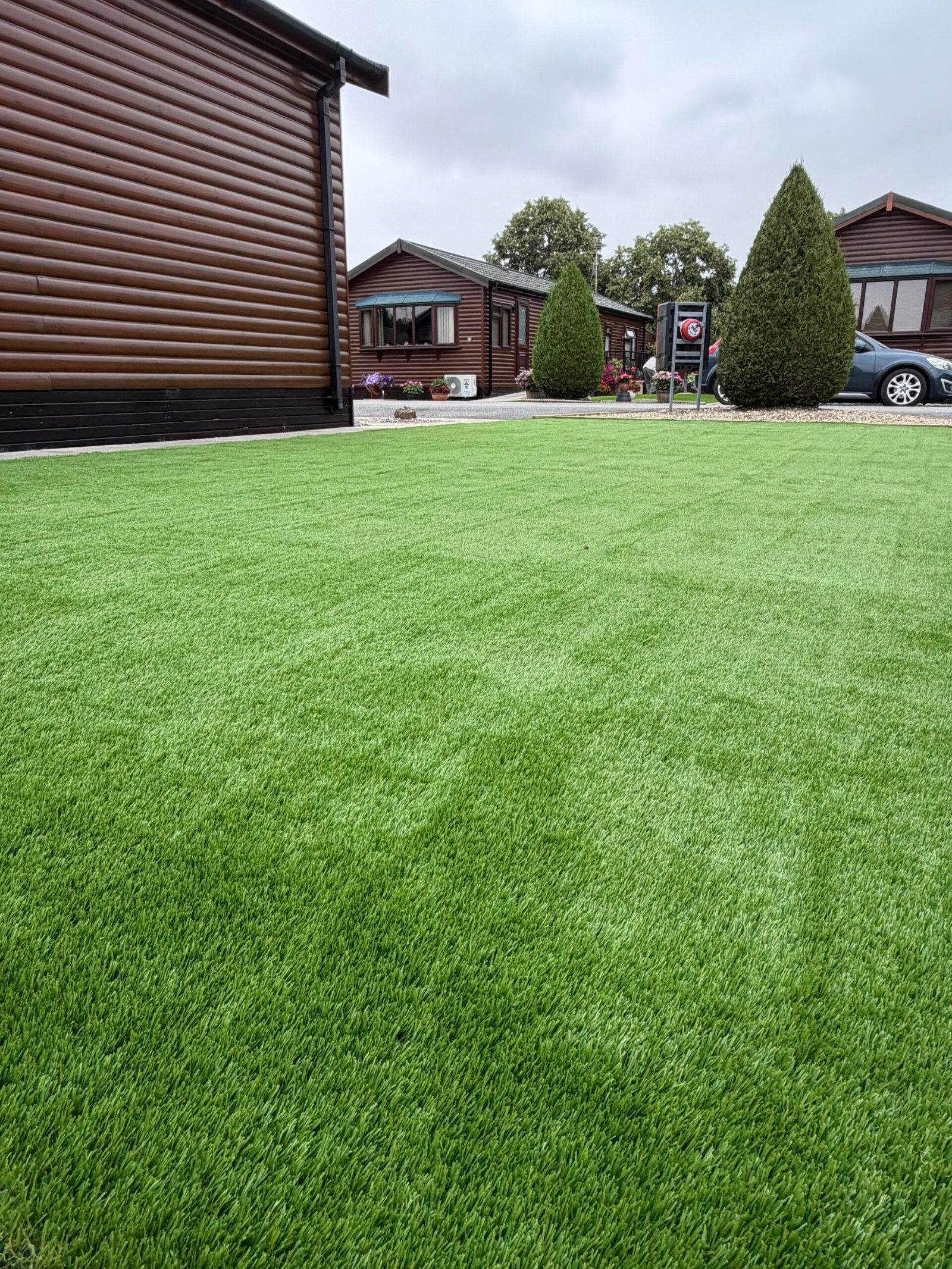 Level lawn against timber cladding in a Lincolnshire garden