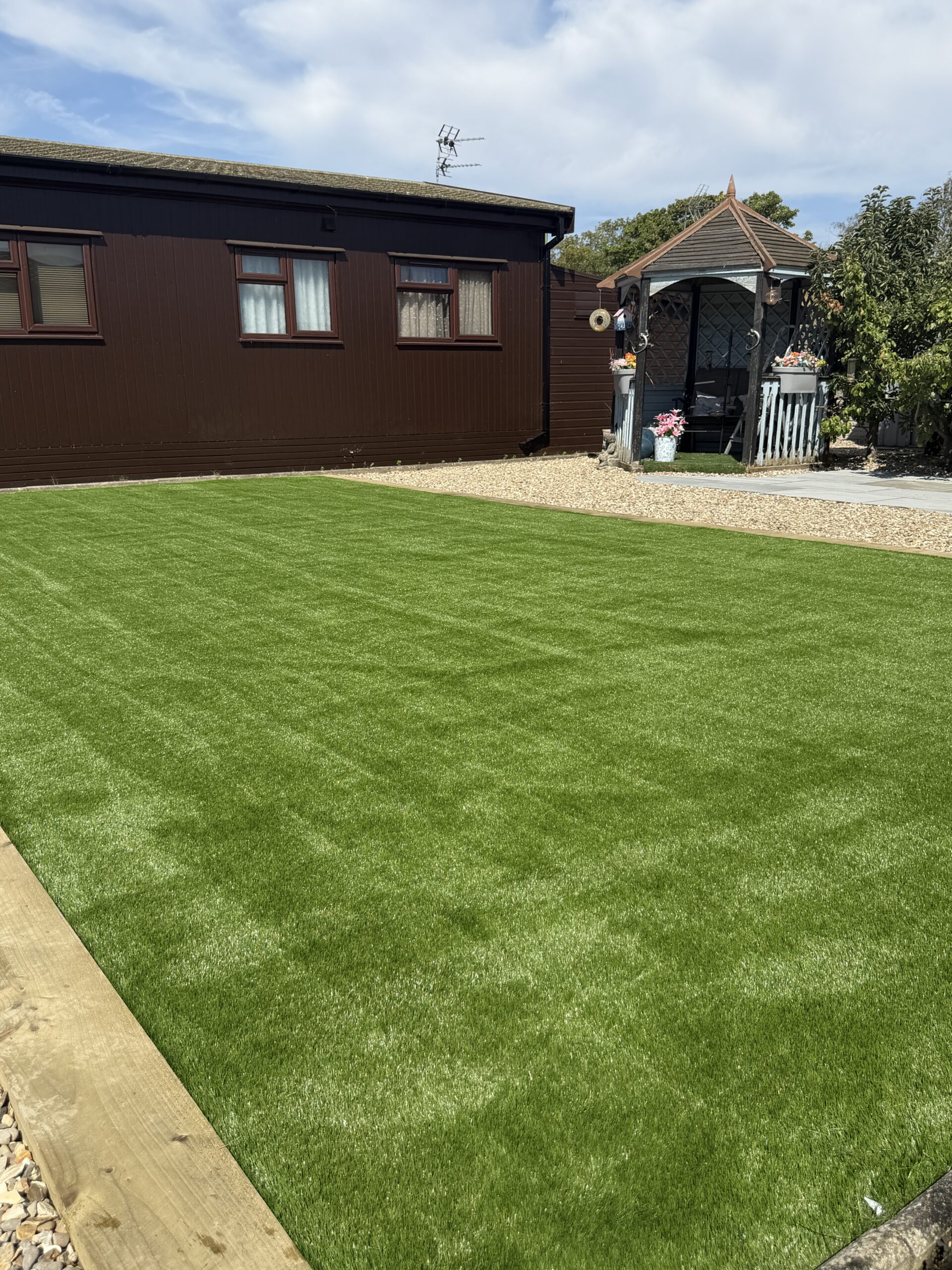 Lawn laid to a clean paved edge in a Lincolnshire garden
