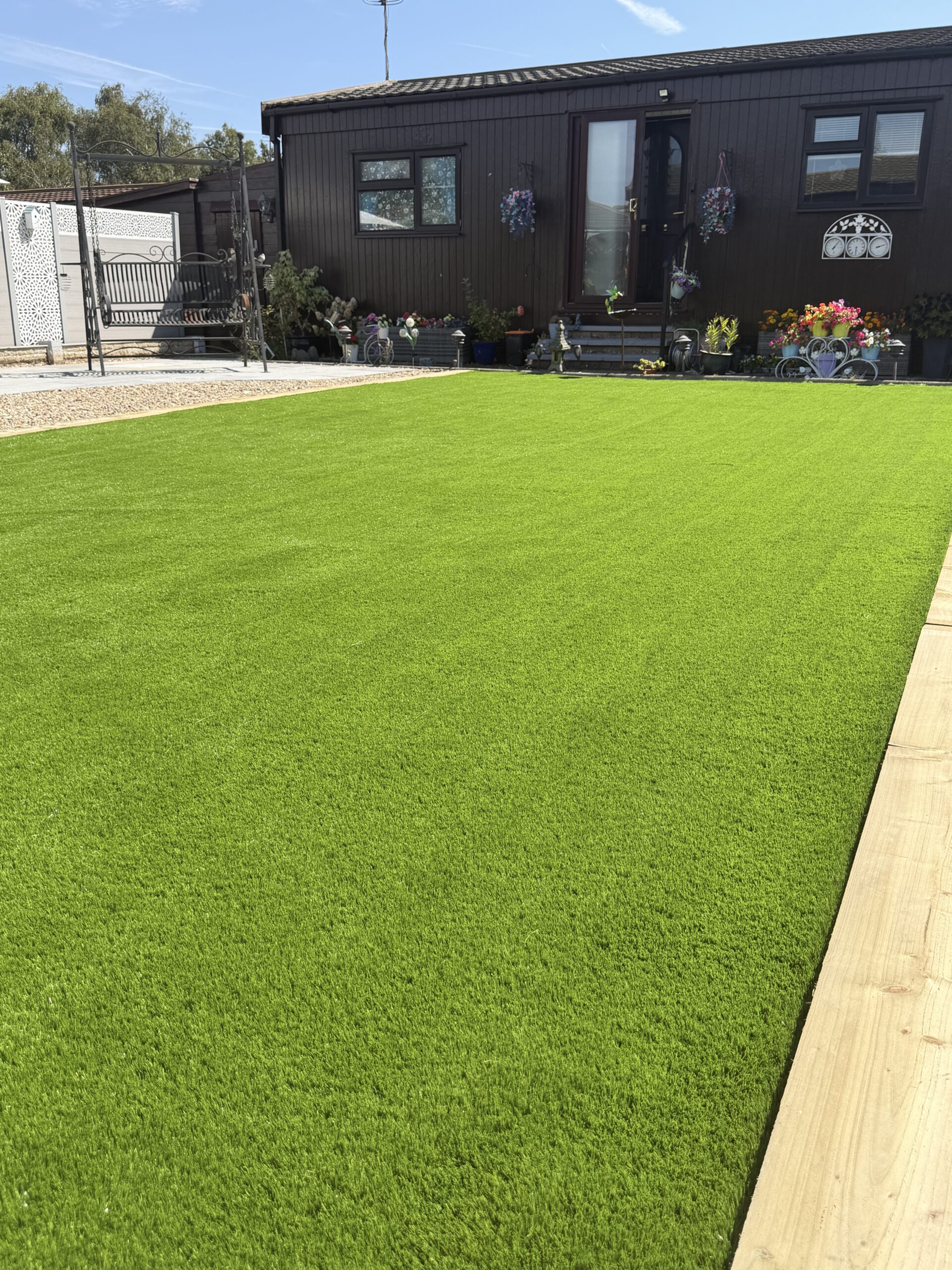 Lawn and paved path in a low maintenance garden near Lincoln