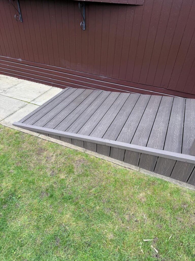 Close up of coffee coloured modern composite decking ramp installation from landscapers in Lincoln.