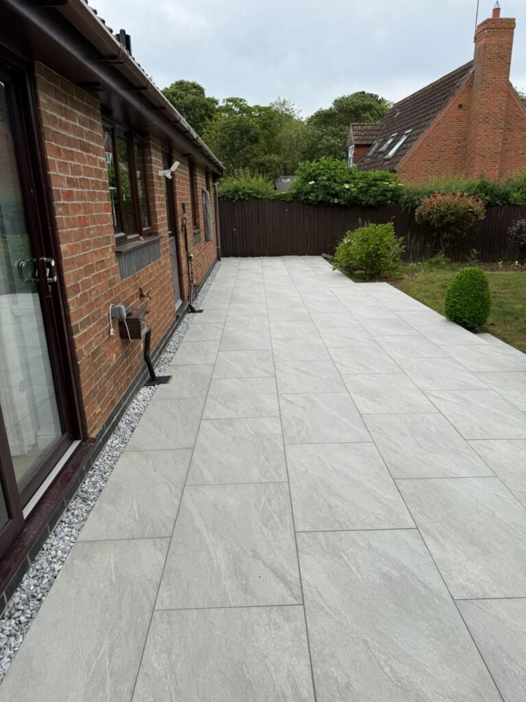 Large grey porcelain patio installation completed by professional landscapers in Lincolnshire UK.