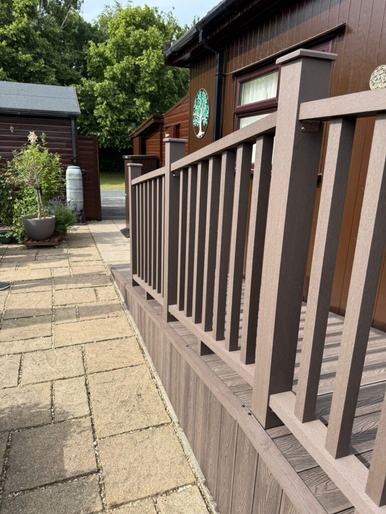 Close-up of modern composite decking and balustrade system with woodgrain finish and durable posts