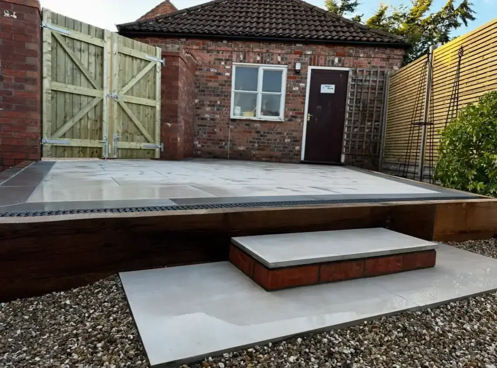 Porcelain patio installation in Gainsborough with timber edging and step