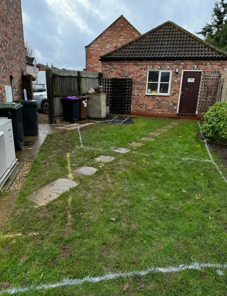 Landscape gardeners in Lincoln marking lawn for patio and pathway installation