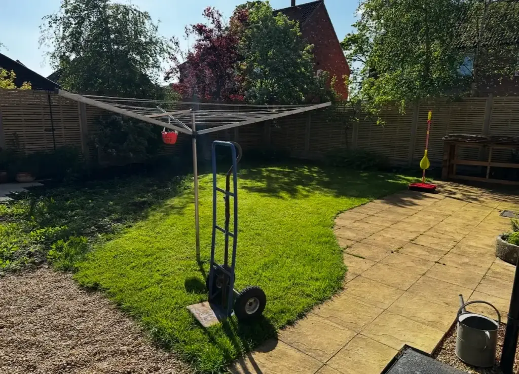 Landscape gardeners in Gainsborough assessing curved lawn and weathered patio installation