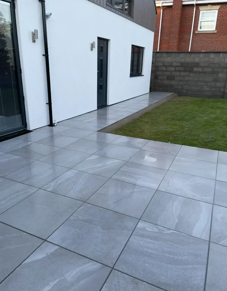 Grey stone-effect porcelain patio installation in Lincoln with precise edges and contemporary finish