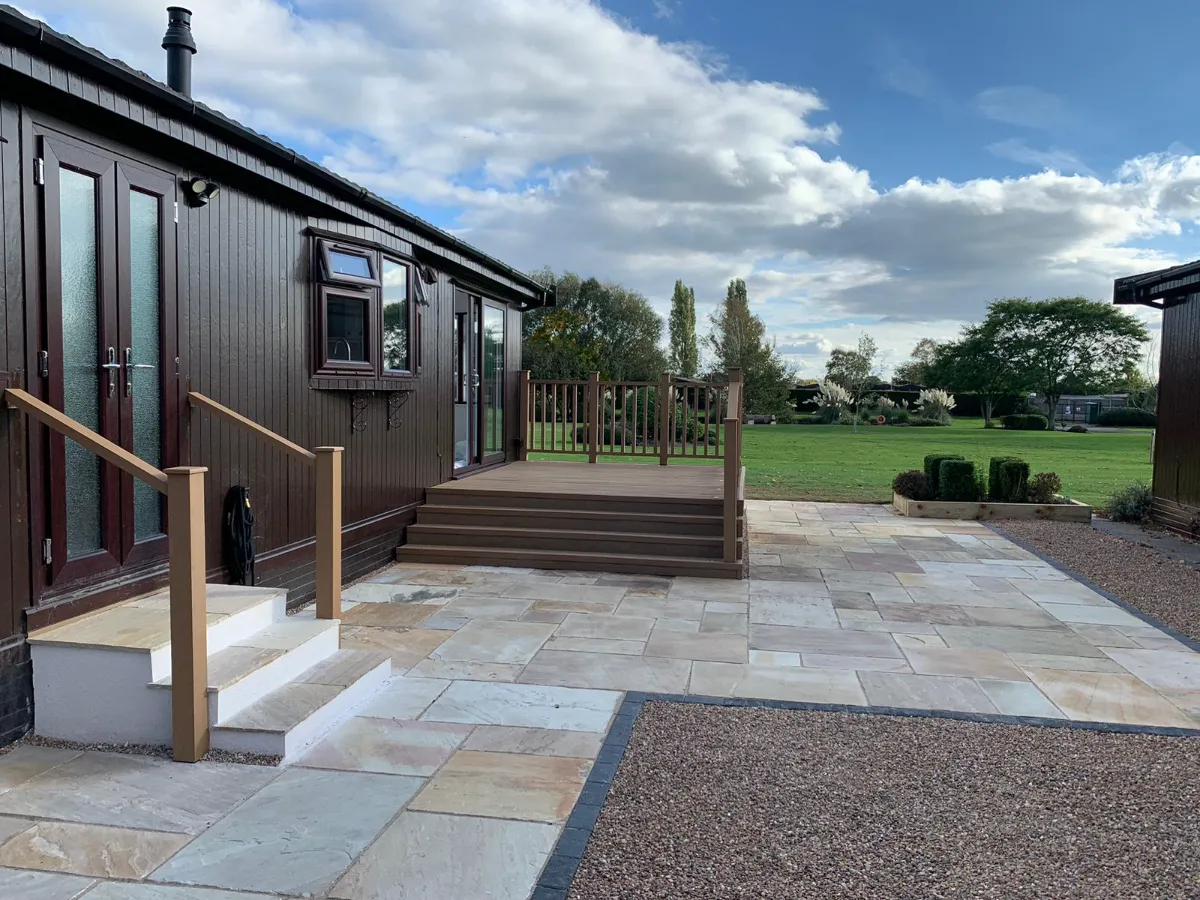 Composite decking with balustrade and steps, Indian sandstone patio and gravel, by Reshape Landscaping in Gainsborough