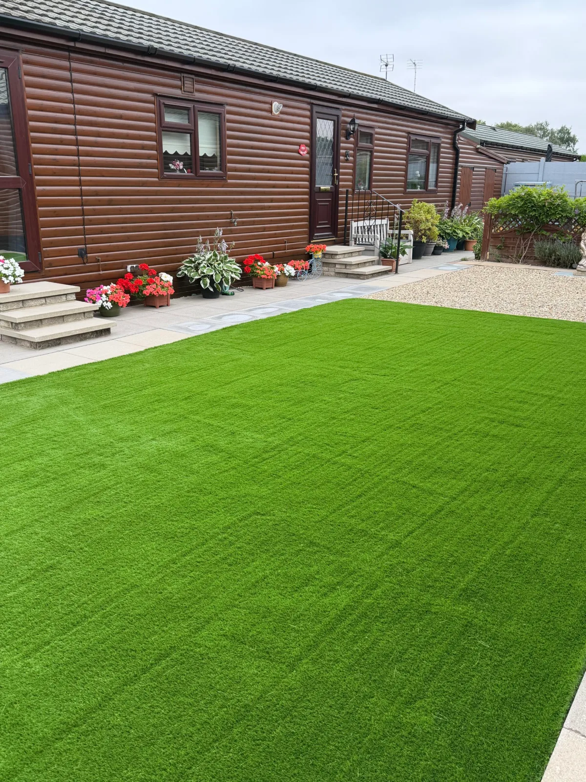 Lawn running up to a patio in a low maintenance garden near Lincoln