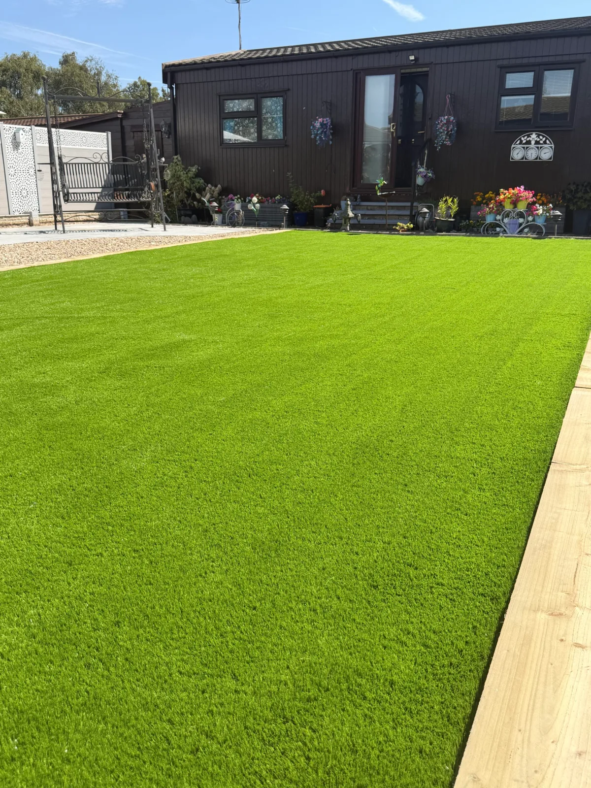 Lawn and paved path in a low maintenance garden near Lincoln