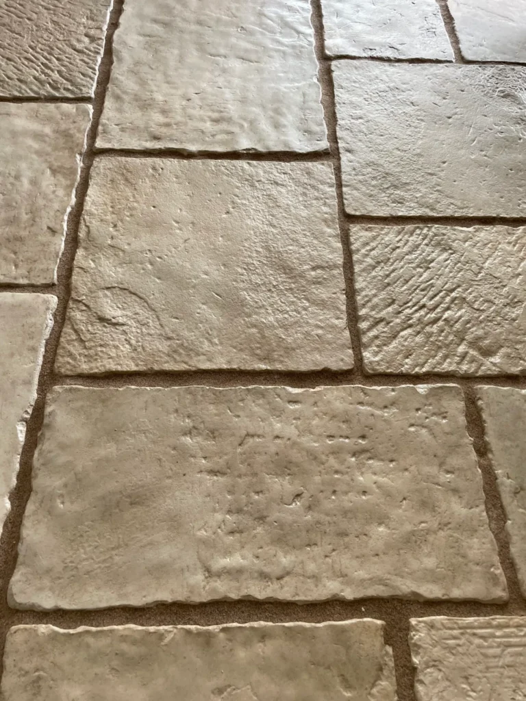 Close-up of hand-finished beige limestone paving with natural riven texture and warm earthy tones. Installed by landscape gardeners in Lincolnshire.