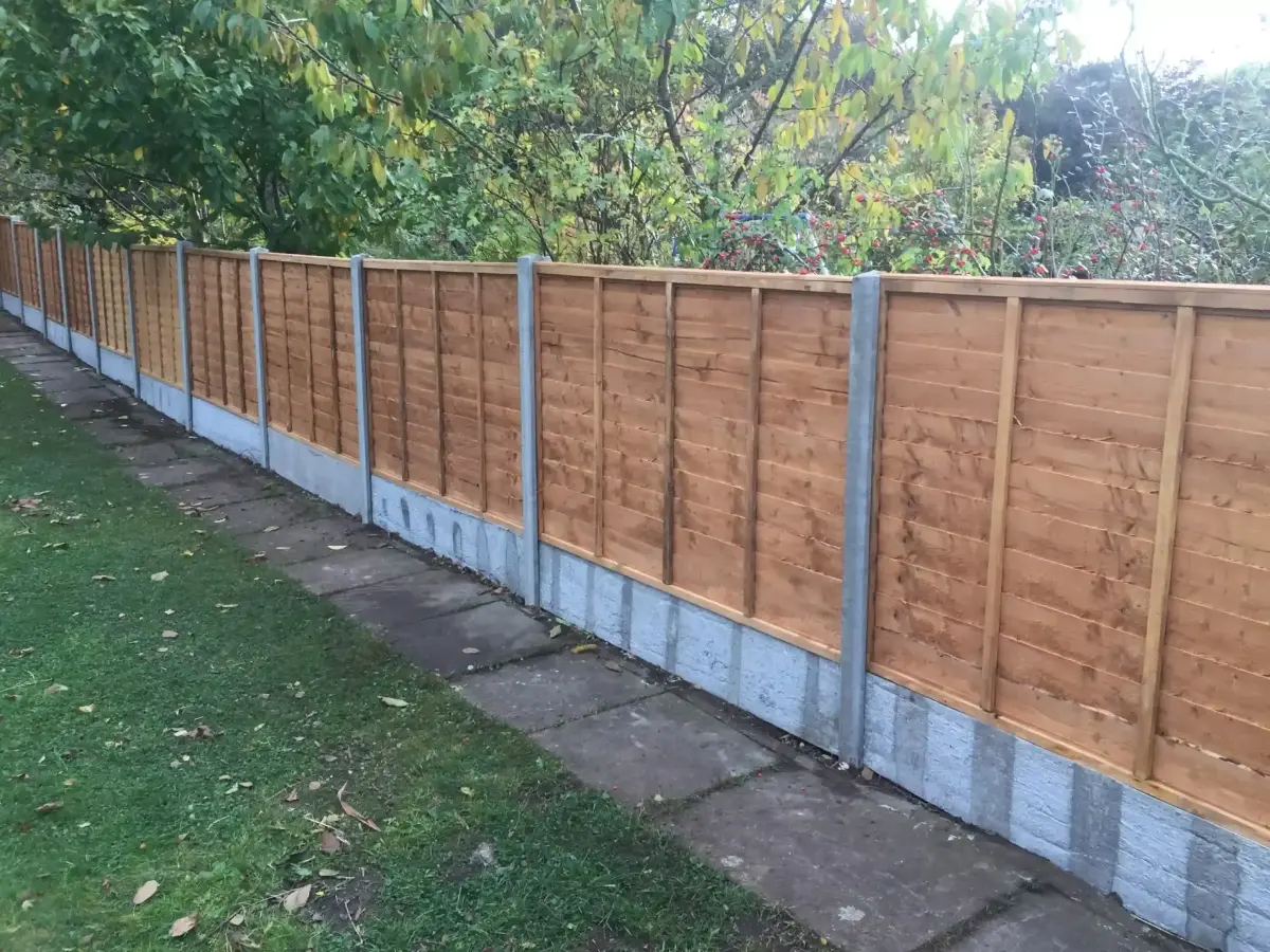 Replacement timber fence panels with concrete posts and gravel boards along a garden path in Lincolnshire
